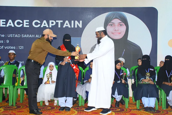 A student receiving the captain&rsquo;s trophy at the PEACE elections ceremony