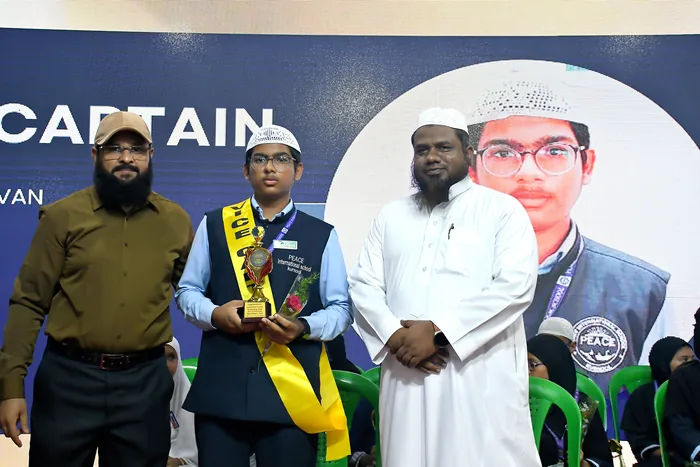 The elected school captain with the trophy and sash of office