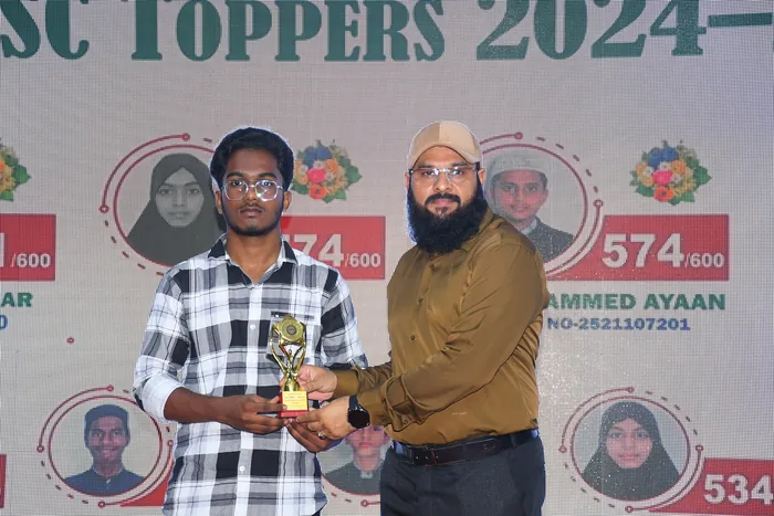 A student receiving a trophy at the SSC toppers felicitation