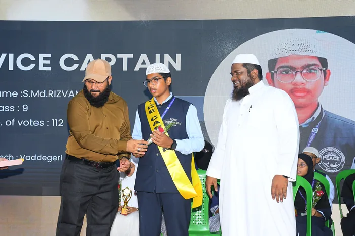 The elected vice captain receiving the trophy and sash of office