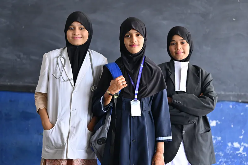 Senior students in professional dress representing medicine, law and engineering