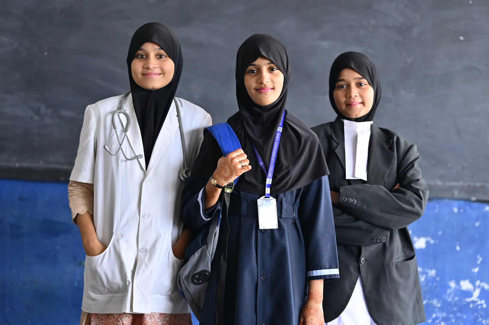 Senior students in professional dress representing medicine, law and engineering
