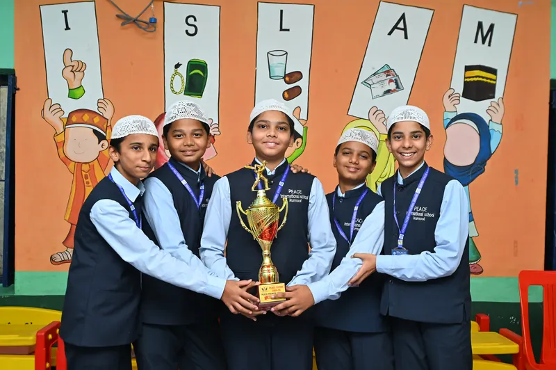 Students celebrating with a trophy after a school competition