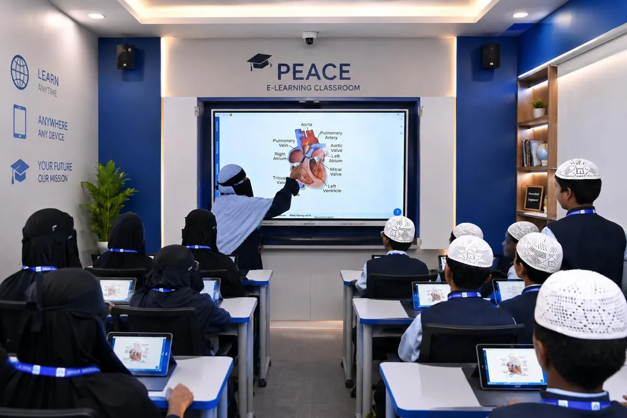 A class following a lesson on the interactive panel in the PEACE e-learning classroom