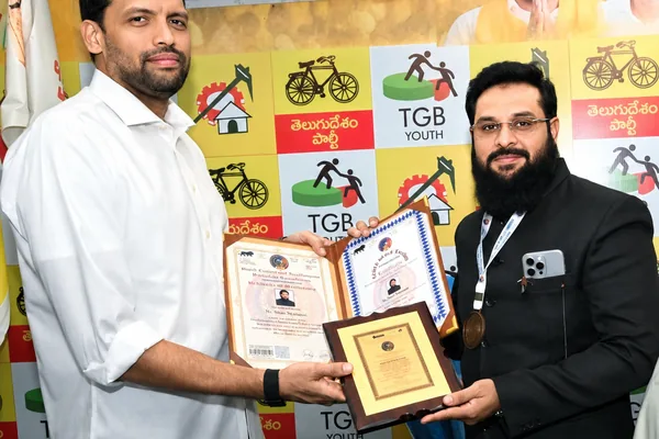 Dr. Shaik Nasir being presented with framed citations and a medal at an award ceremony