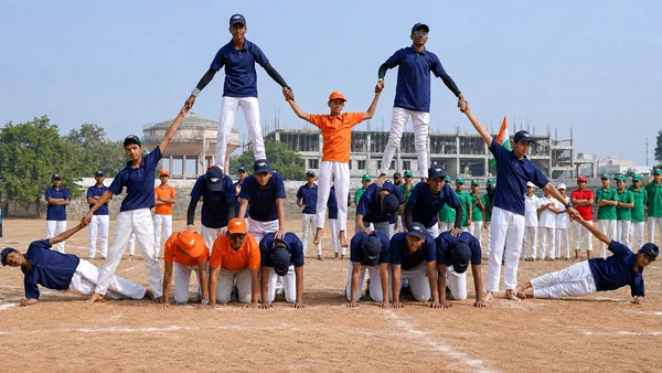 Students holding a human pyramid on the ground during the Sports Day display — Peace English Medium School, Kurnool