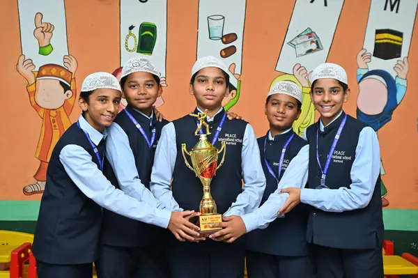 A winning team holding their trophy after an inter-house competition — Peace English Medium School, Kurnool
