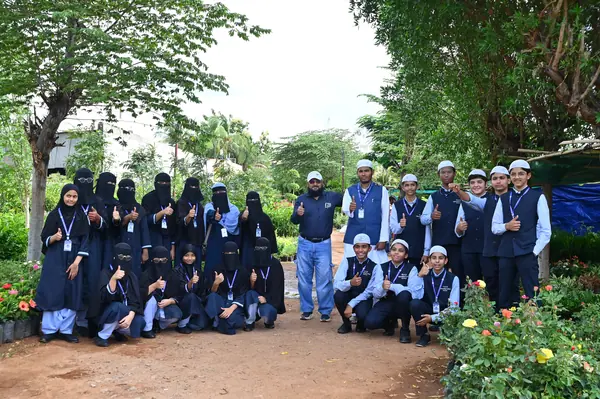 The group photographed among the beds on a visit to a plant nursery — Peace English Medium School, Kurnool