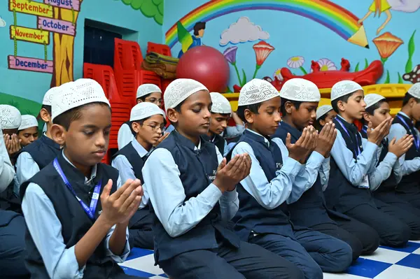 Students with their hands raised in dua during the daily prayer — Peace English Medium School, Kurnool