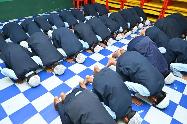 Rows of students in sujood in the prayer hall — Peace English Medium School, Kurnool