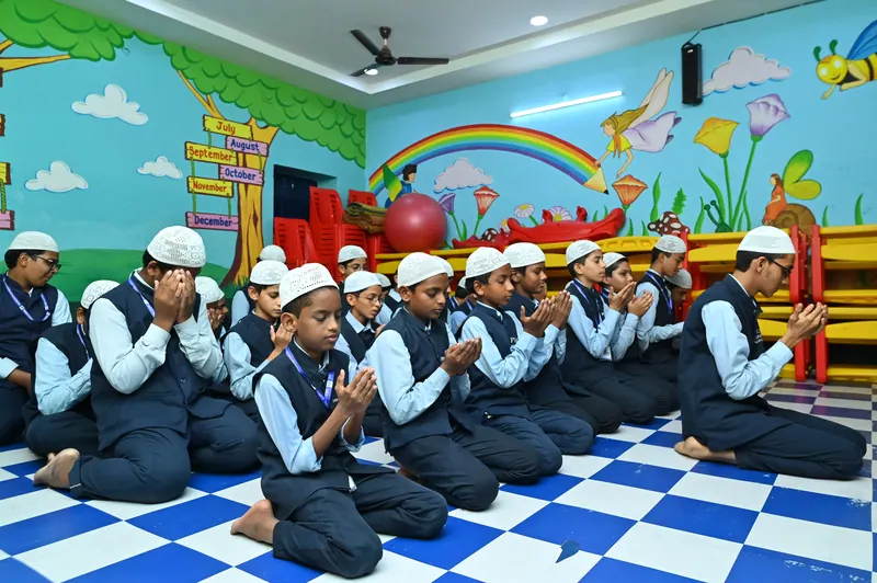 Students seated in rows in the school prayer hall
