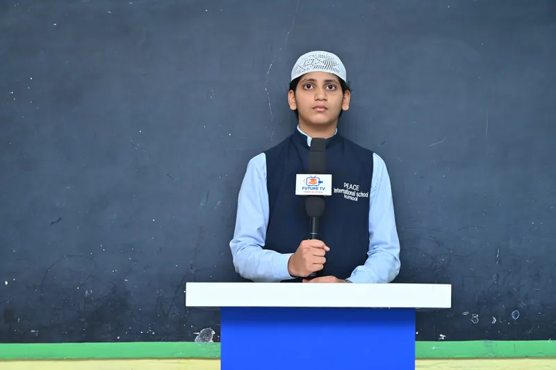 A student speaking into a microphone on stage during the Peace Talent Stage
