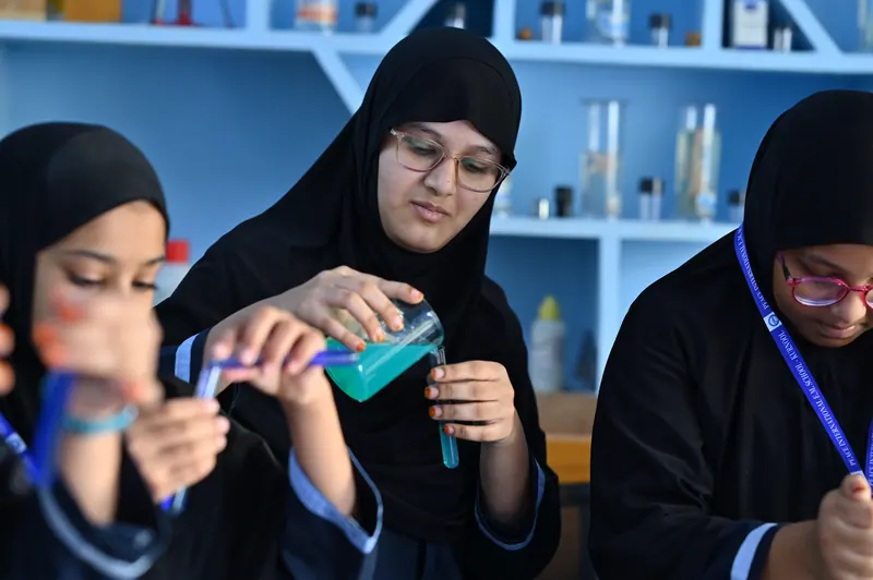 Students demonstrating a chemistry experiment during the school science exhibition
