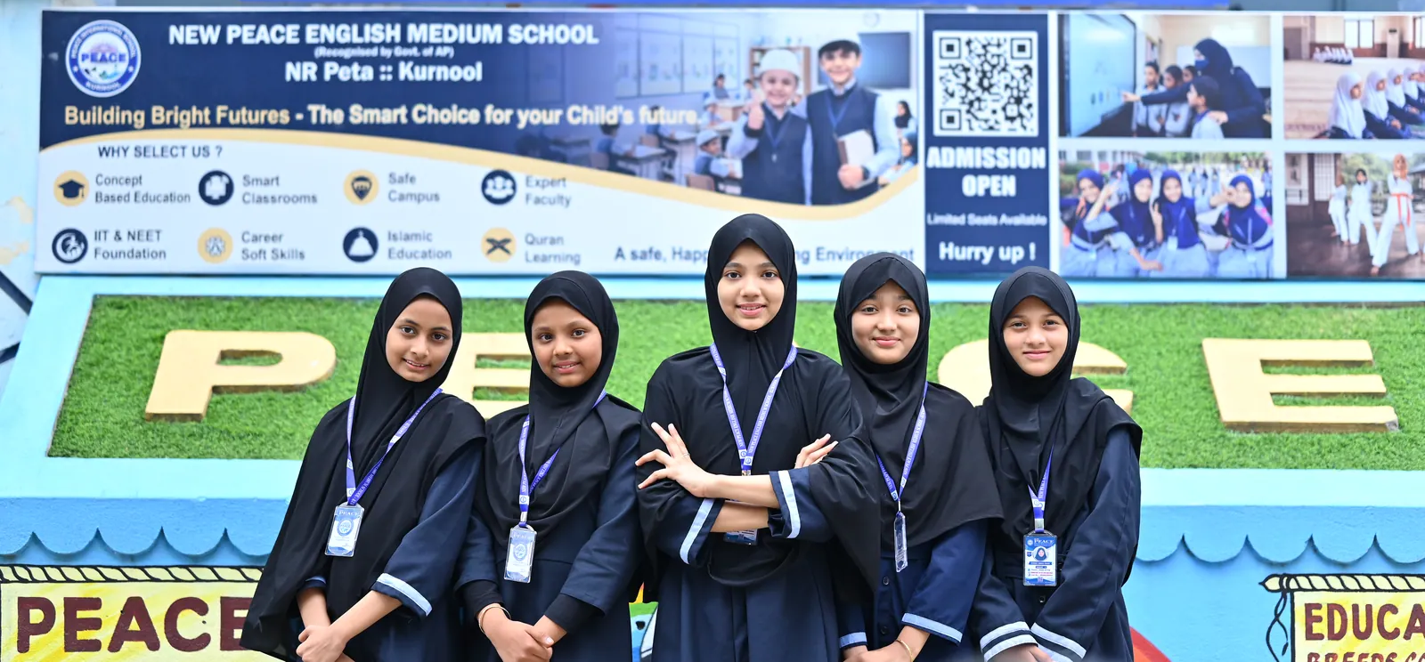 Students of Peace English Medium School standing together beside the school banner