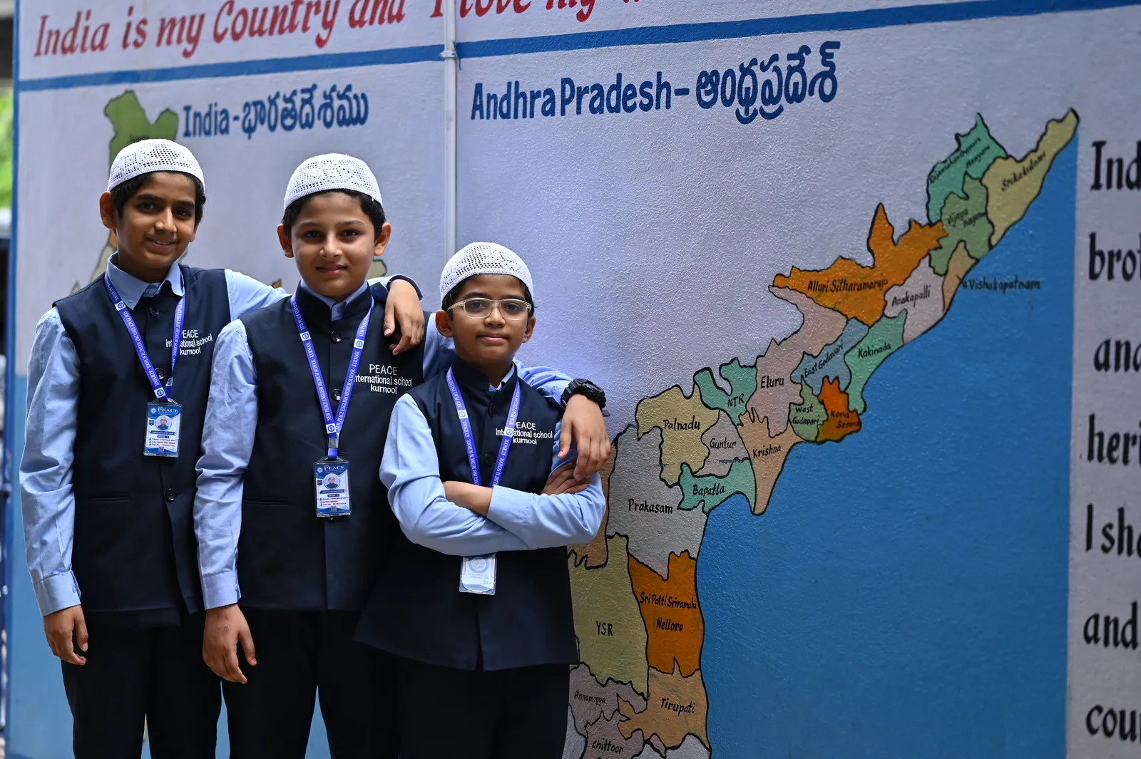 Students standing before a map of India and Andhra Pradesh during a civics lesson